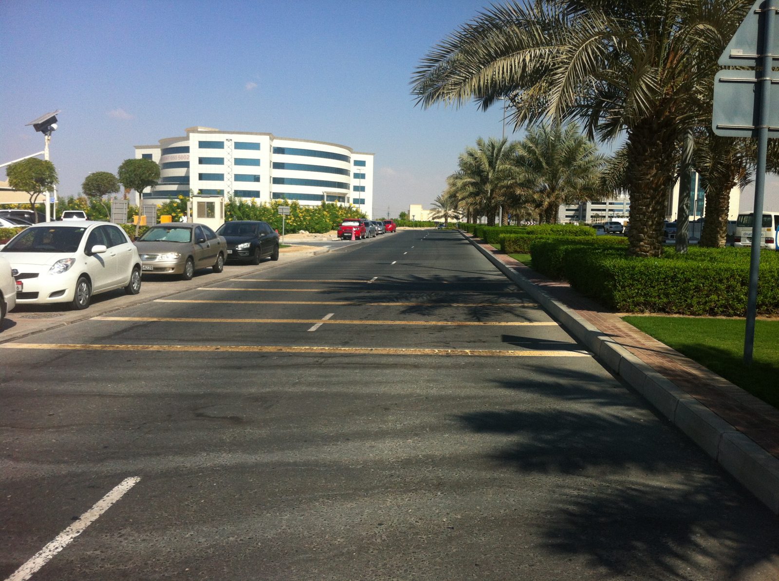 Wide road and undeveloped plots between campus buildings in Dubai International Academic City, photographed in 2012.