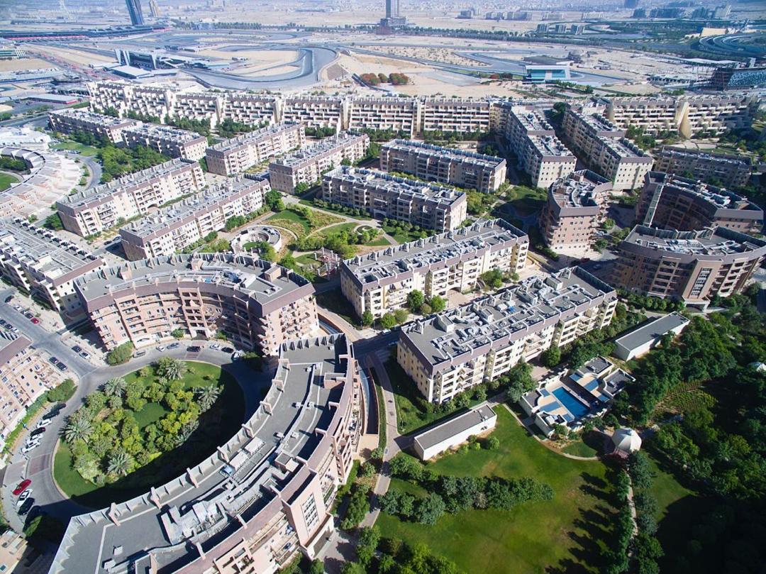 Residential towers and street-level retail in Motor City, Dubai, photographed in 2020.