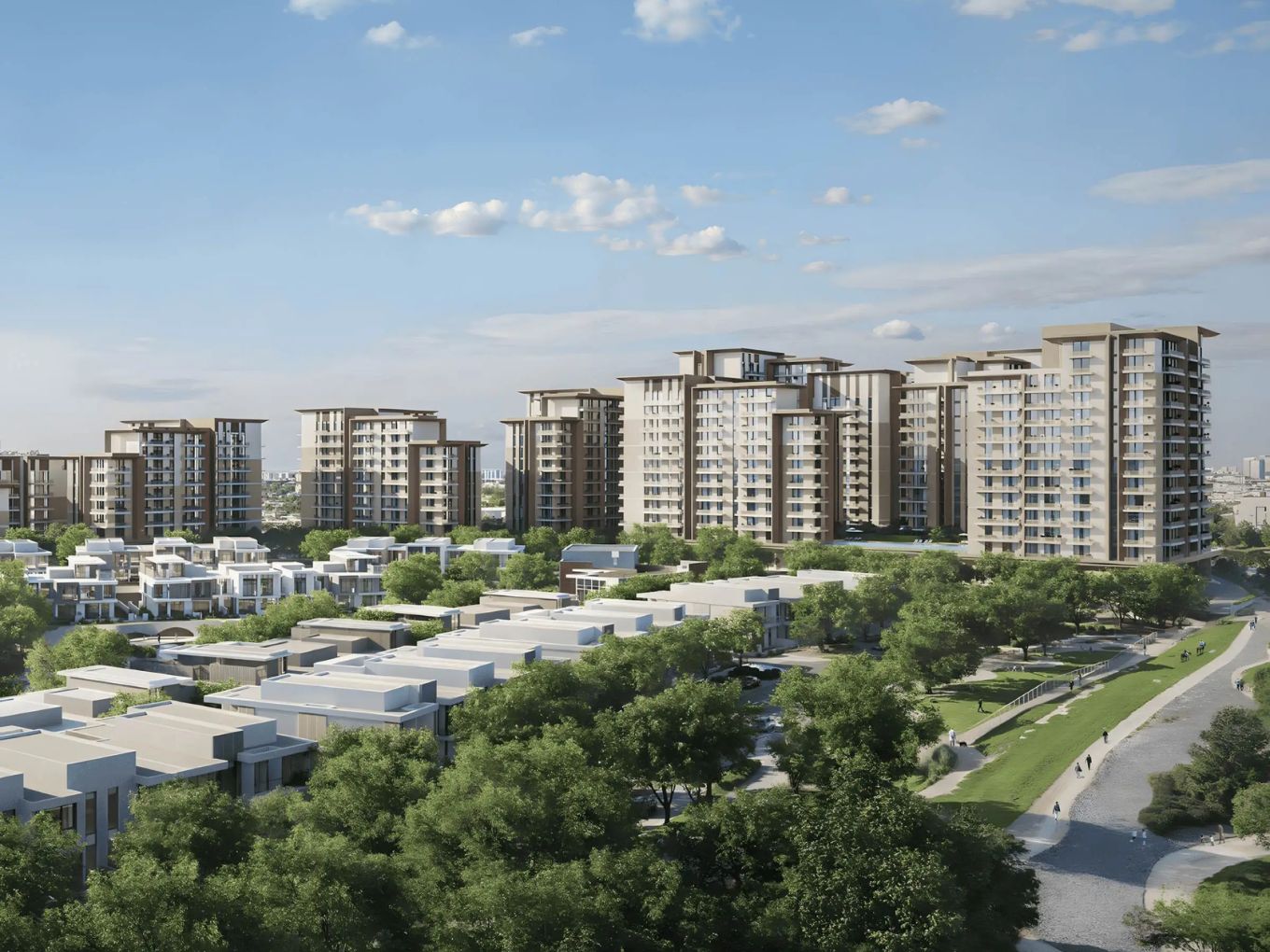 Aerial view of the Expo Valley Views apartment blocks rising behind low rise villas at Expo City Dubai