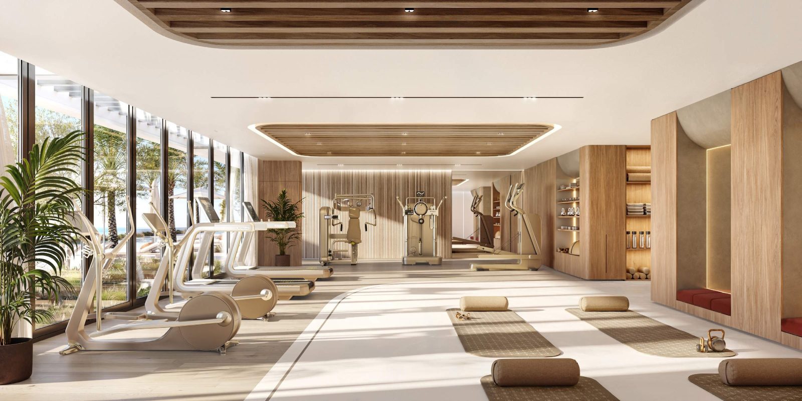 Gymnasium at SOMA Residences with cardio and resistance equipment and full-height glazing onto planting