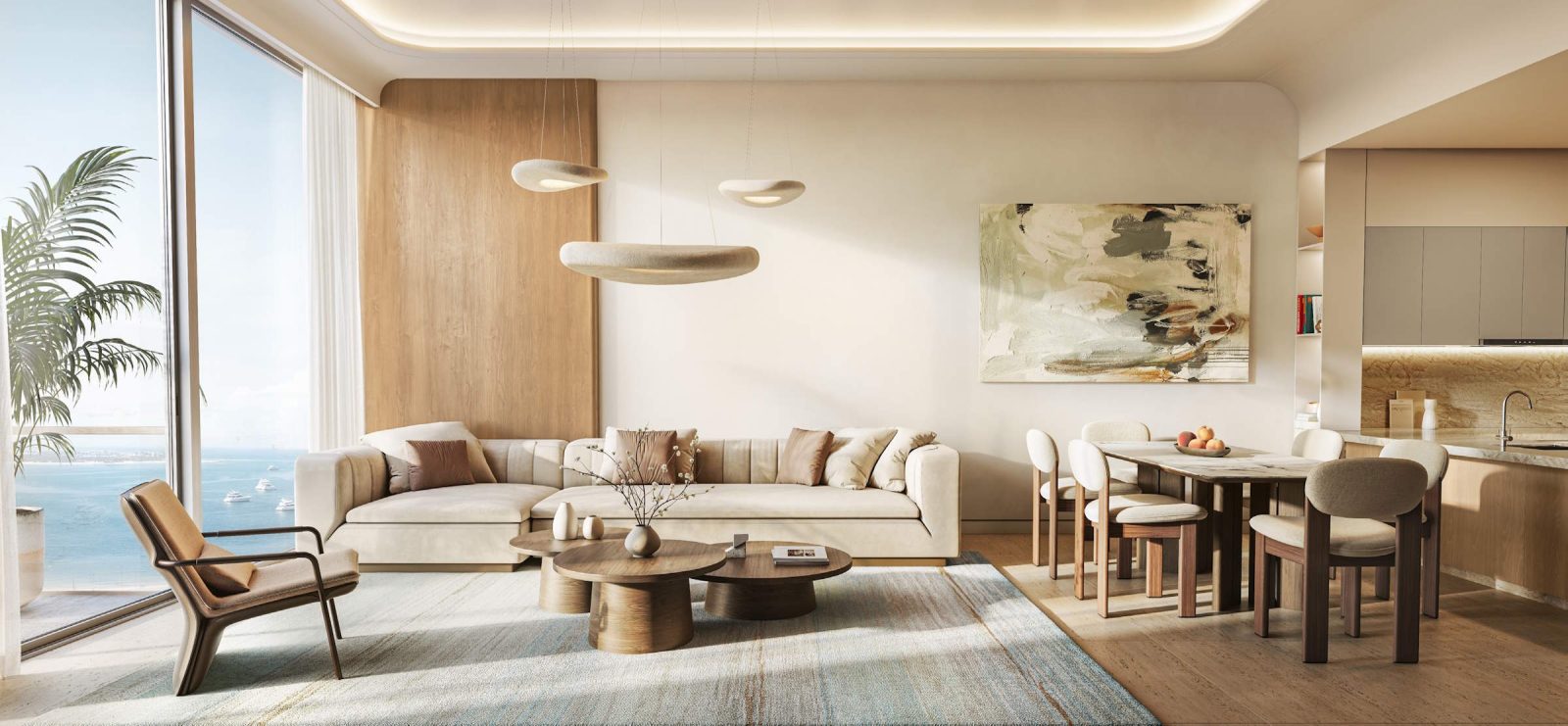 Living and dining area in an apartment at SOMA Residences with sea views through full-height glazing
