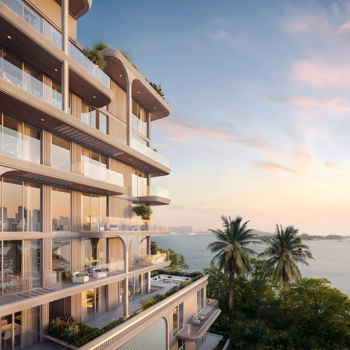Sea-facing elevation of SOMA Residences at dusk, with planted balconies overlooking the water