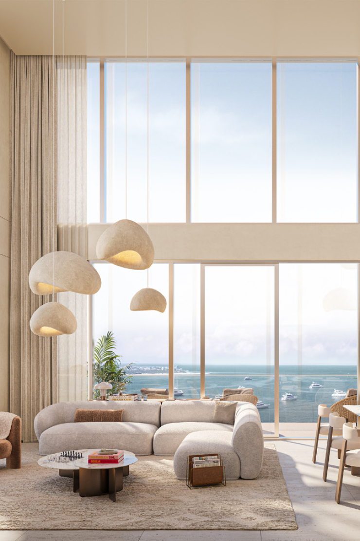 Render of a double-height living space in a SOMA Residences duplex, overlooking the water