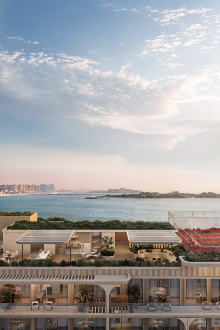 Render of the roof terrace at SOMA Residences, with shaded dining, a sports court and views across the water to the Dubai coastline